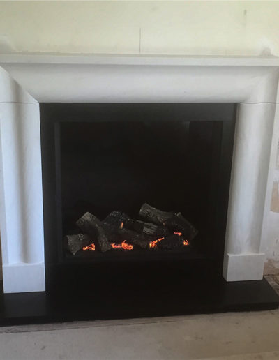 11326 Gazco Riva 750HL with Arlington surround in Limestone and honed black granite hearth