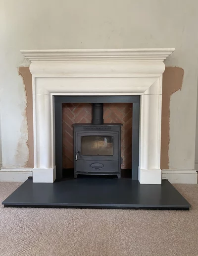 3140 Limestone surround with Honed granite hearth and Herringbone brick panel